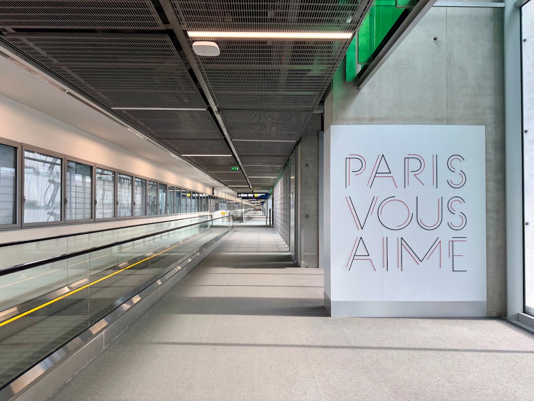 Modern airport walkway with "paris vous aime" art