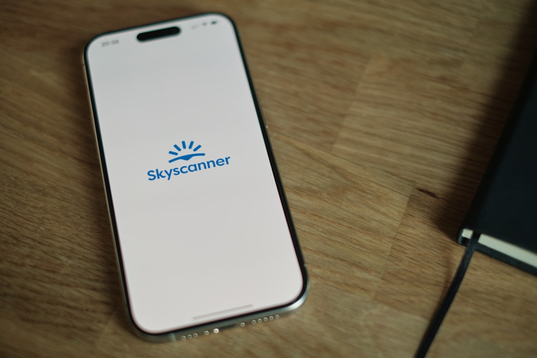 A cell phone sitting on top of a wooden table